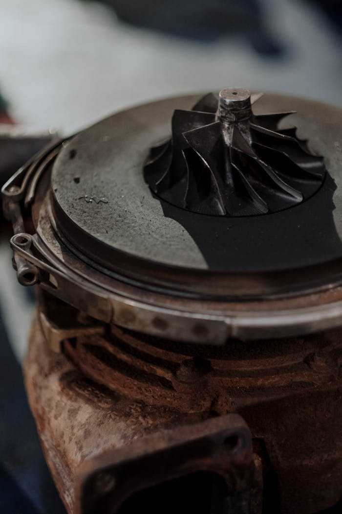 about-bg Detailed shot of a rusty turbocharger showing metal components and engine parts.